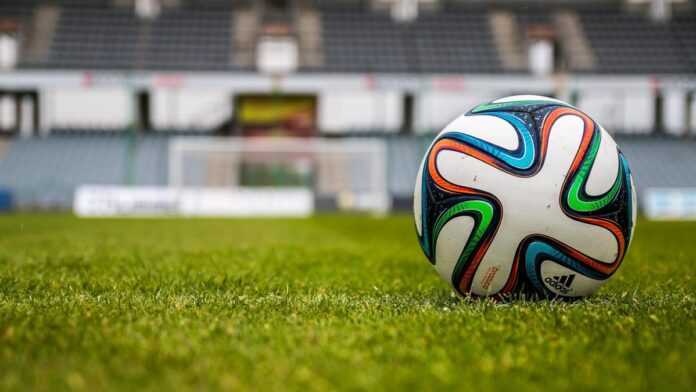 A soccer ball on a pitch A soccer ball on a pitch